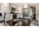 Modern kitchen with stainless steel appliances, white cabinetry, and hardwood floors at 2949 River Bay N Dr, Indianapolis, IN 46240