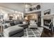 Open-concept living room featuring a fireplace, hardwood floors, and view to the kitchen and upstairs loft at 2949 River Bay N Dr, Indianapolis, IN 46240