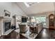 Cozy living room featuring a fireplace, vaulted ceiling, skylights, and natural light at 2949 River Bay N Dr, Indianapolis, IN 46240