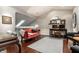 Bright office space with a skylight, featuring a desk, sofa, and hardwood floors at 2949 River Bay N Dr, Indianapolis, IN 46240