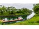 Scenic waterfront view featuring boat dock and lush greenery enhancing the property's appeal at 2949 River Bay N Dr, Indianapolis, IN 46240