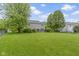 Large grassy backyard with fenced perimeter and mature trees at 3014 Saddlehorn Dr, Carmel, IN 46033