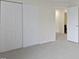 This bedroom has a closet and access door, plus neutral walls and carpet at 3014 Saddlehorn Dr, Carmel, IN 46033