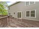 Exterior shot of the home featuring a wooden deck with railing and sliding glass doors at 3014 Saddlehorn Dr, Carmel, IN 46033