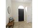Well-lit foyer features a stylish bench, tiled floor and an arched front door at 3014 Saddlehorn Dr, Carmel, IN 46033