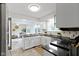 Modern kitchen with black countertops, white cabinets, stainless steel appliances, and an open layout at 3014 Saddlehorn Dr, Carmel, IN 46033