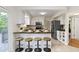 Bright kitchen features modern bar seating and tile flooring, perfect for casual dining and entertaining at 3014 Saddlehorn Dr, Carmel, IN 46033