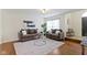 Cozy living room with plush sofas, a modern glass coffee table, and hardwood floors at 3014 Saddlehorn Dr, Carmel, IN 46033