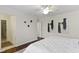 Bright main bedroom featuring hardwood floors, a ceiling fan, and closet access at 3014 Saddlehorn Dr, Carmel, IN 46033