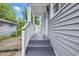 Covered back porch and steps offer a peaceful outdoor space with grey siding and white trim at 3334 N Chester Ave, Indianapolis, IN 46218