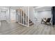 Basement with an open-concept design featuring stairs, living area, and modern flooring at 3334 N Chester Ave, Indianapolis, IN 46218