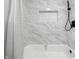 Elegant bathroom featuring marble-style tile, a niche, and a sleek black shower fixture at 3334 N Chester Ave, Indianapolis, IN 46218