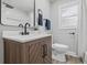 Updated bathroom with modern vanity, updated fixtures and gray tiling at 3334 N Chester Ave, Indianapolis, IN 46218