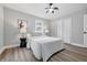 Neutral bedroom with ceiling fan, featuring one large window and wood-look flooring at 3334 N Chester Ave, Indianapolis, IN 46218