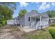 This lovely home with gray siding features an inviting outdoor space and detached garage at 3334 N Chester Ave, Indianapolis, IN 46218