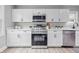 Modern kitchen with white cabinets, quartz countertops and stainless steel appliances at 3334 N Chester Ave, Indianapolis, IN 46218