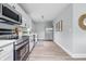 Bright kitchen featuring white cabinets, stainless appliances, and modern fixtures at 3334 N Chester Ave, Indianapolis, IN 46218