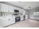 Bright kitchen featuring white cabinets, stainless appliances, and modern fixtures at 3334 N Chester Ave, Indianapolis, IN 46218