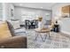 Sunlit living room featuring contemporary furniture, a patterned rug, and open dining space at 3334 N Chester Ave, Indianapolis, IN 46218