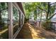 Large deck with sliding glass doors, grill, and furniture overlooking a serene lake view at 3585 Bay Rd N Dr, Indianapolis, IN 46240