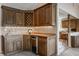 Wet bar features custom cabinets, wine rack, sink, and beverage cooler at 3585 Bay Rd N Dr, Indianapolis, IN 46240