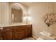 A bathroom boasts a vanity, carpet, a mirror, wallpaper, and a toilet at 3585 Bay Rd N Dr, Indianapolis, IN 46240