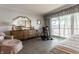 The bedroom includes a comfortable chair, a dresser, exercise equipment, and views of the lake at 3585 Bay Rd N Dr, Indianapolis, IN 46240