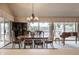 An elegant dining room features views of the lake, carpeted floors, a chandelier, and a piano at 3585 Bay Rd N Dr, Indianapolis, IN 46240