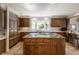 Spacious kitchen features wood cabinets, center island with cooktop and lots of storage at 3585 Bay Rd N Dr, Indianapolis, IN 46240