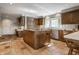 Kitchen with center island, tiled floor, wood cabinets, and lots of natural light at 3585 Bay Rd N Dr, Indianapolis, IN 46240