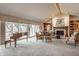 Spacious living room features a fireplace, vaulted ceilings, and large windows with a lake view at 3585 Bay Rd N Dr, Indianapolis, IN 46240