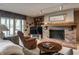 Cozy living room features a brick fireplace, built-in shelves, and lake views at 3585 Bay Rd N Dr, Indianapolis, IN 46240