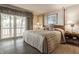 A main bedroom boasts a walkout balcony with lake views and a four-poster bed at 3585 Bay Rd N Dr, Indianapolis, IN 46240