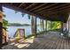 Covered patio with brick flooring and comfortable seating overlooking the lake at 3585 Bay Rd N Dr, Indianapolis, IN 46240