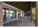 Spacious covered patio with brick flooring, lounge chairs, and scenic lake views at 3585 Bay Rd N Dr, Indianapolis, IN 46240