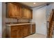 A charming wet bar with wooden cabinets, sink, and mini-refrigerator at 3585 Bay Rd N Dr, Indianapolis, IN 46240