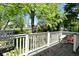 Cozy back porch featuring outdoor furniture and leafy tree views at 3668 Chatsbee Ct, Indianapolis, IN 46224
