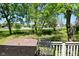Back porch featuring outdoor furniture and lush, green backyard views at 3668 Chatsbee Ct, Indianapolis, IN 46224