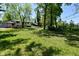 A spacious backyard featuring vibrant green grass and mature trees at 3668 Chatsbee Ct, Indianapolis, IN 46224