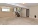 Unfinished basement featuring stairs and a window at 3668 Chatsbee Ct, Indianapolis, IN 46224