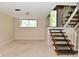 Unfinished basement with carpet flooring and staircase at 3668 Chatsbee Ct, Indianapolis, IN 46224