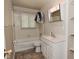 Bright bathroom features tub shower combo, toilet, and vanity with storage space at 3668 Chatsbee Ct, Indianapolis, IN 46224