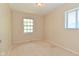 Neutral bedroom features carpeted floor and two windows for ample natural light at 3668 Chatsbee Ct, Indianapolis, IN 46224