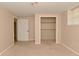 A light-filled bedroom boasts a closet and neutral carpet at 3668 Chatsbee Ct, Indianapolis, IN 46224