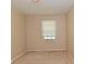 A basic bedroom with beige walls, neutral carpet, and a window with blinds at 3668 Chatsbee Ct, Indianapolis, IN 46224