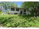 View of the white single Gathering home with lush green front yard and mature trees at 3668 Chatsbee Ct, Indianapolis, IN 46224
