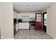 Bright kitchen features stainless steel appliances, white cabinetry, and access to the back yard at 3668 Chatsbee Ct, Indianapolis, IN 46224
