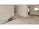 Living room view featuring neutral walls, staircase, and dining room access at 3668 Chatsbee Ct, Indianapolis, IN 46224