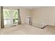 Living room featuring large windows, neutral walls, staircase, and carpet at 3668 Chatsbee Ct, Indianapolis, IN 46224