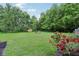 The backyard includes mature trees, manicured shrubs and a fire pit providing a private outdoor gathering space at 3713 W 98Th St, Carmel, IN 46032